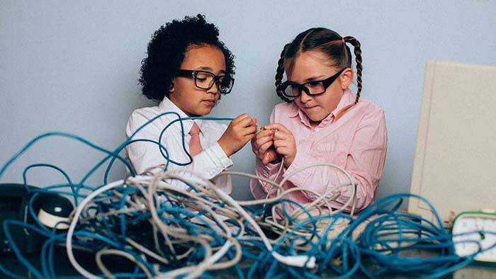 "Illustration de deux jeunes filles travaillant avec des câbles informatiques"
